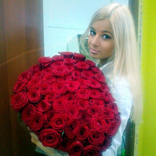 a blonde with a bouquet of roses